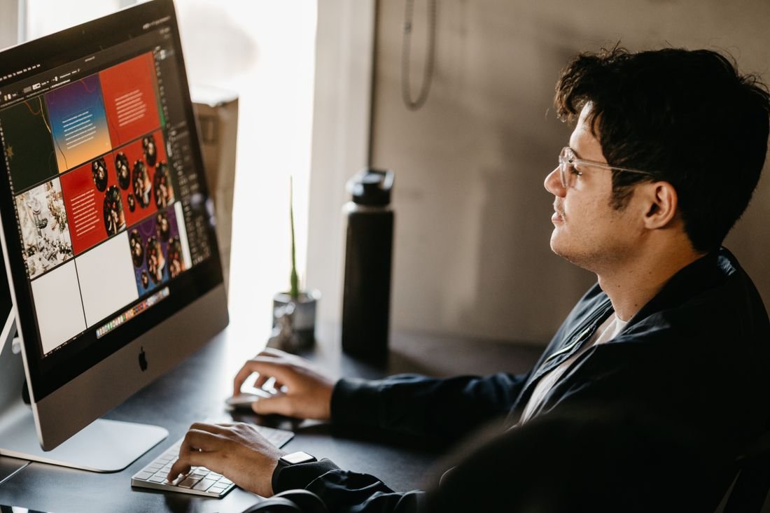 Designer working on campaign artwork at a large screen